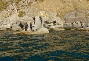 Divers atop the rock outcrop which served as shore anchor for the Sucia receiver.